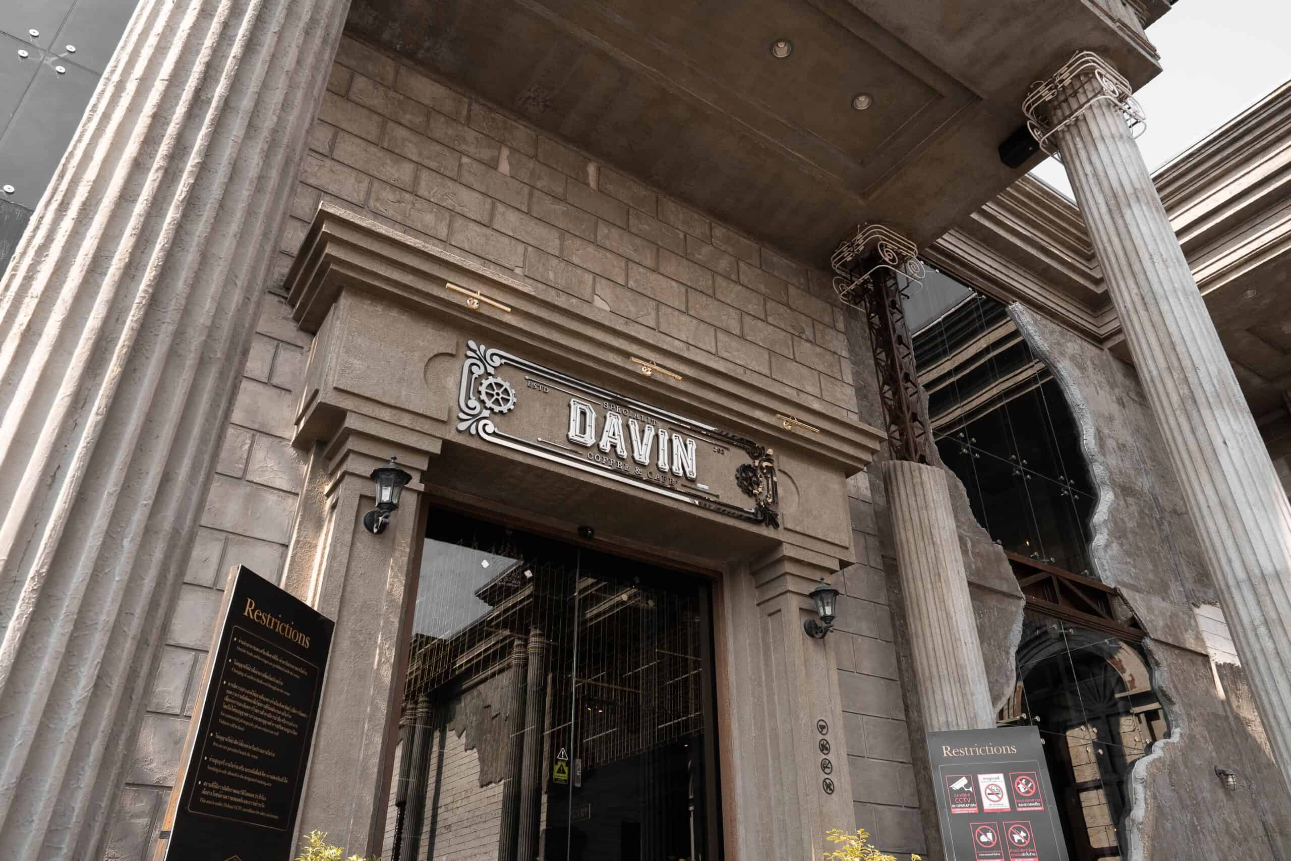 Grand entrance of Davin Cafe in Ram Inthra with industrial architecture and neoclassical pillars, showcasing the cafe’s signature style