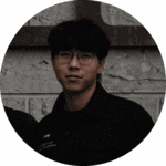 A professional portrait of a male staff member with glasses from Davin Cafe wearing a black uniform.