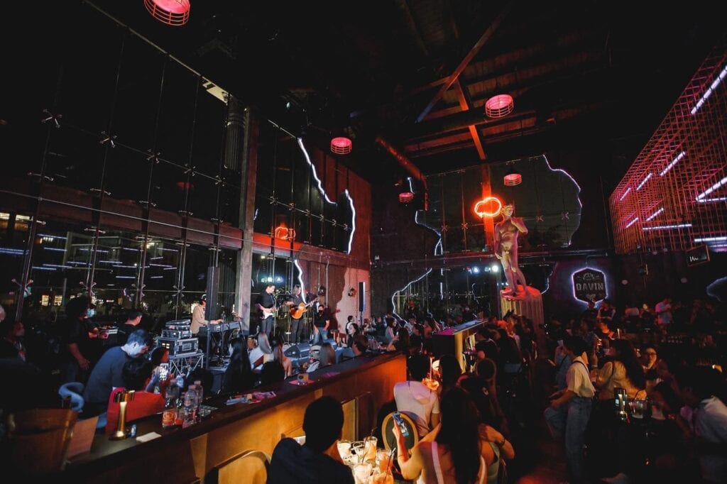 A vibrant New Year event venue featuring a live music performance, atmospheric lighting, and a lively crowd celebrating together, showcasing a premium space designed for year-end parties, social gatherings, and memorable New Year celebrations