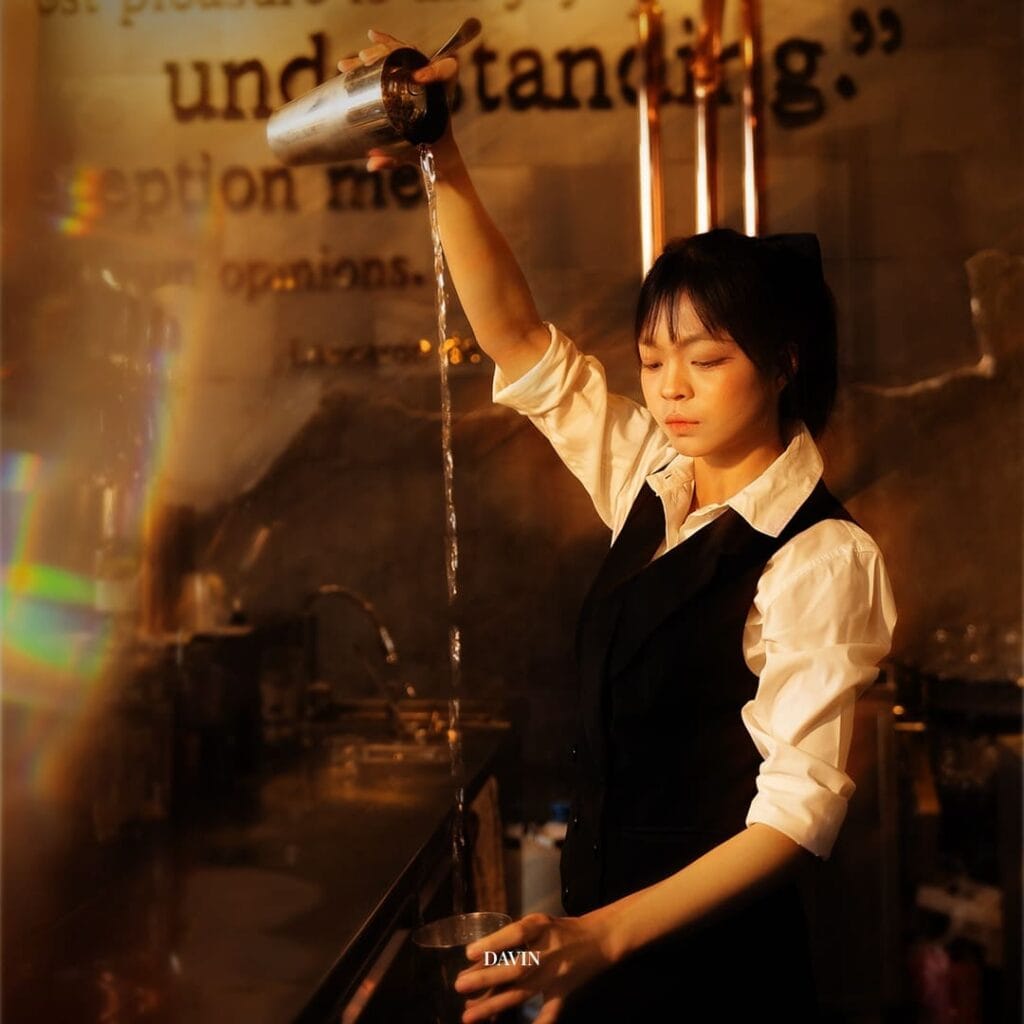 Bartender pouring a craft drink in a night hangout bar, warm lighting atmosphere designed for relaxed drinking, socializing, and intimate conversations