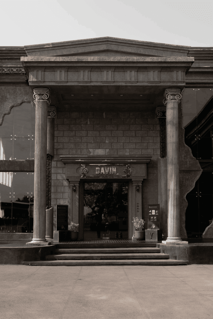 An iconic photogenic cafe in Ram Inthra featuring European-inspired architectural design at Davin Cafe, with grand stone columns and an industrial-luxury facade, ideal for photography, cafe hopping, and visual content creation