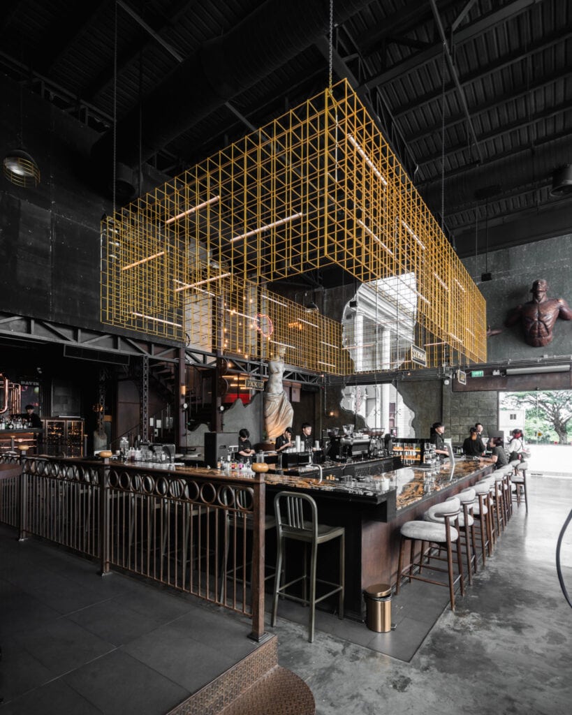 Near me café in Ramintra at Davin Cafe showcasing an iconic industrial interior with a long bar counter and distinctive metal structure design