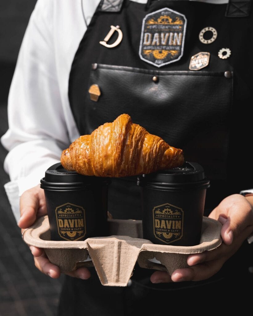 Premium bakery croissant served with coffee to go, perfect for everyday takeaway enjoyment