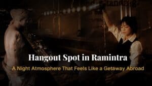 Premium hangout bar with a warm nighttime atmosphere, industrial interior design, and bartender preparing drinks for a relaxed evening experience