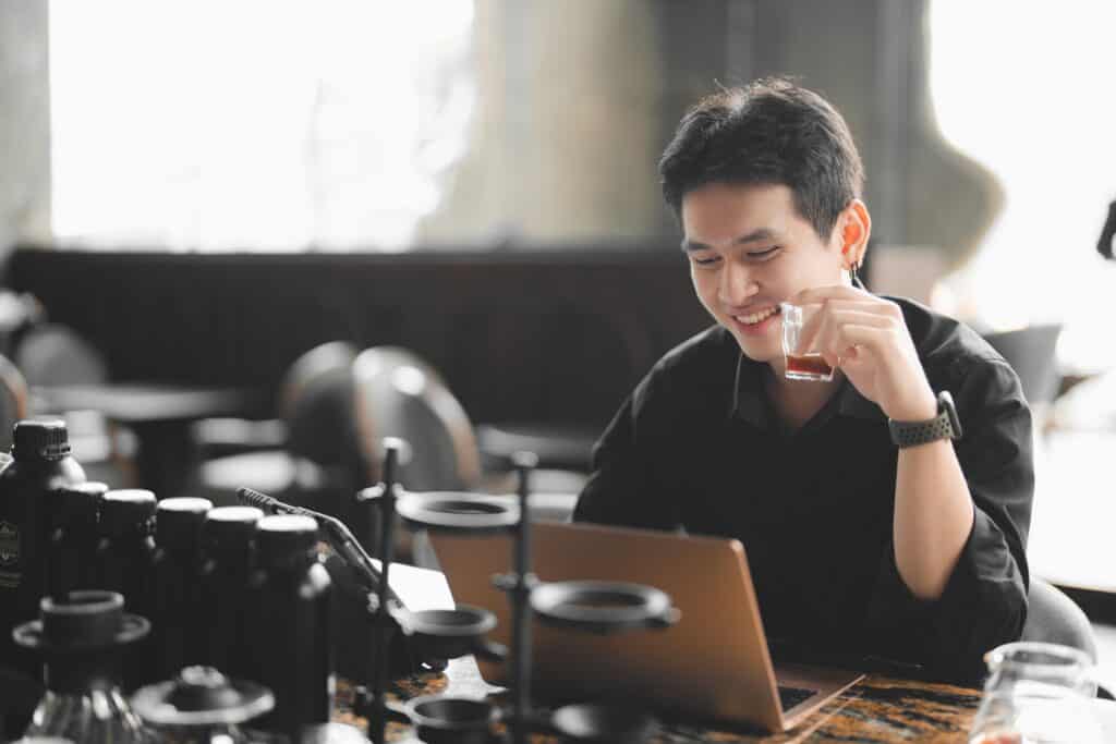 Customer working on a laptop while enjoying espresso at Davin Cafe, a work-friendly coffee shop in Ramintra