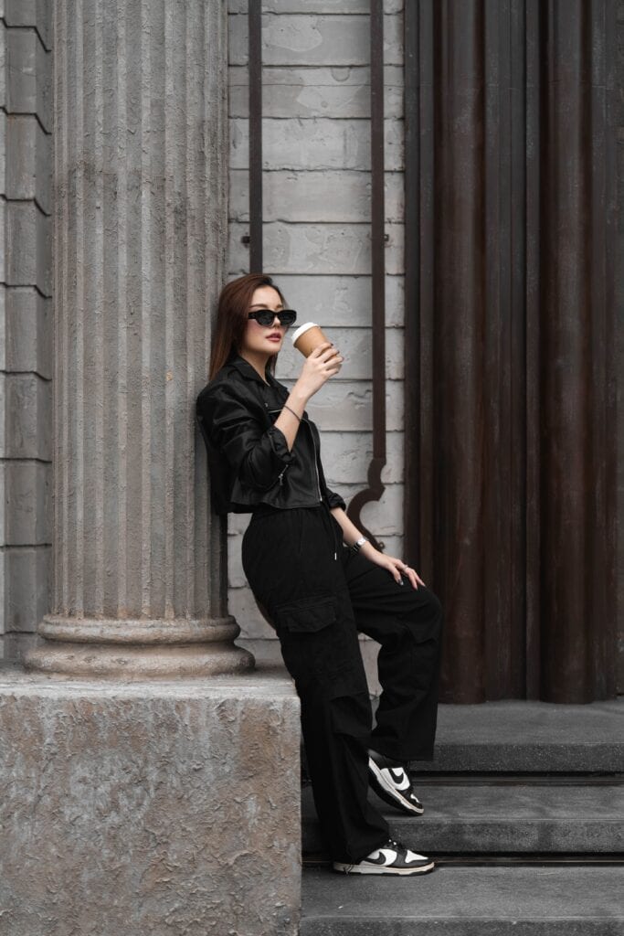 A stylish woman enjoying coffee at a photogenic cafe with bold architectural design at Davin Cafe, perfect for lifestyle photography, cafe hopping, and visual content creation