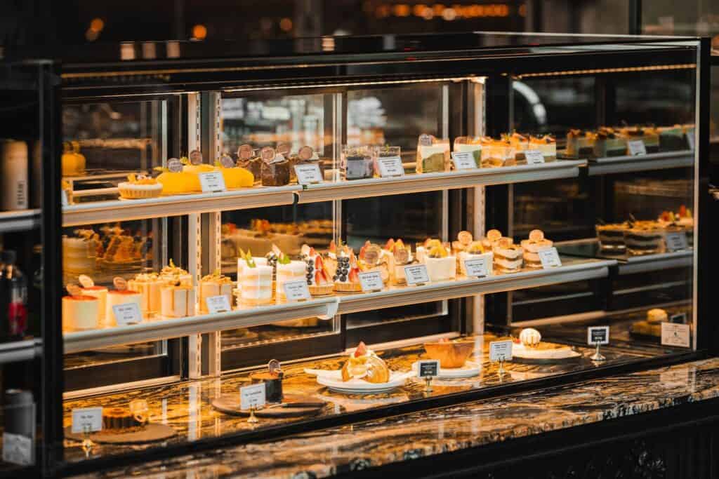 Curated pastry and artisan cake display at Davin Cafe in Bangkok, featuring handcrafted desserts arranged in a premium glass showcase—highlighting the quality, freshness, and visual experience expected from a leading bakery Bangkok destination.