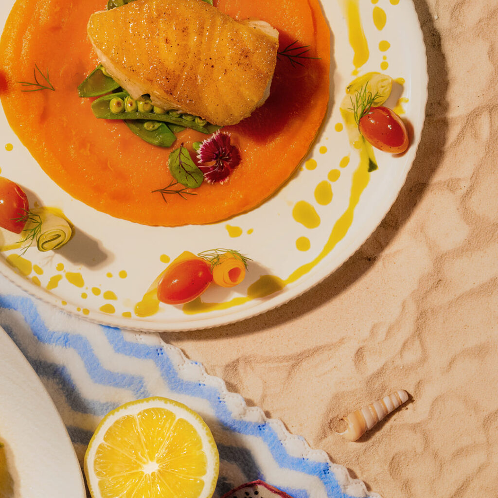 Davin Cafe's 'Sunset surrender' summer drink, a refreshing vibrant yellow beverage served in the signature golden DAVIN takeaway cup, perfect for a photo-worthy moment or enjoyment on the go.