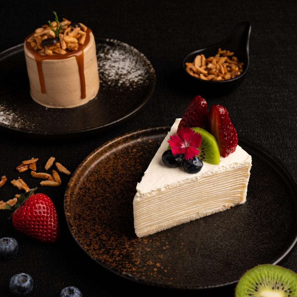 Delicious cake cafe premium fresh fruit crepe cake dessert with strawberry kiwi and blueberry at a European style dessert cafe