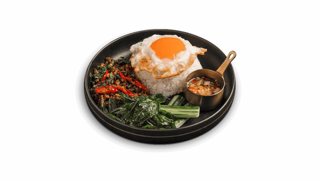 BEEF BASIL STIR-FRY WITH RICE at DAVIN CAFE restaurant Bangkok featuring savory Thai stir-fried beef with holy basil, steamed rice and fried egg with rich yolk, a signature Thai restaurant dish in Bangkok for authentic food lovers