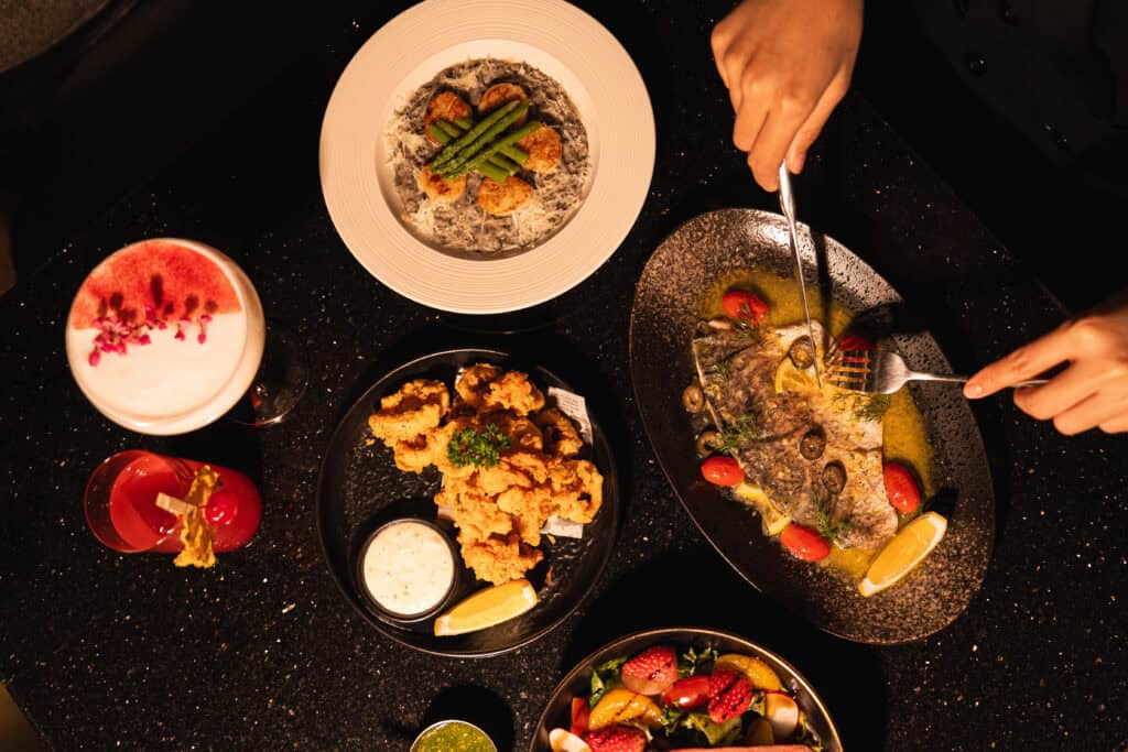 Gourmet dinner spread at DAVIN CAFE, a good atmosphere dinner spot featuring seafood, steak, fried appetizers, and signature cocktails, perfect for an elegant and memorable evening dining experience