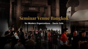 A lively seminar and workshop setting at Davin Cafe in Bangkok, featuring engaged participants in both seated sessions and interactive activities, highlighting its capability as a versatile corporate event venue