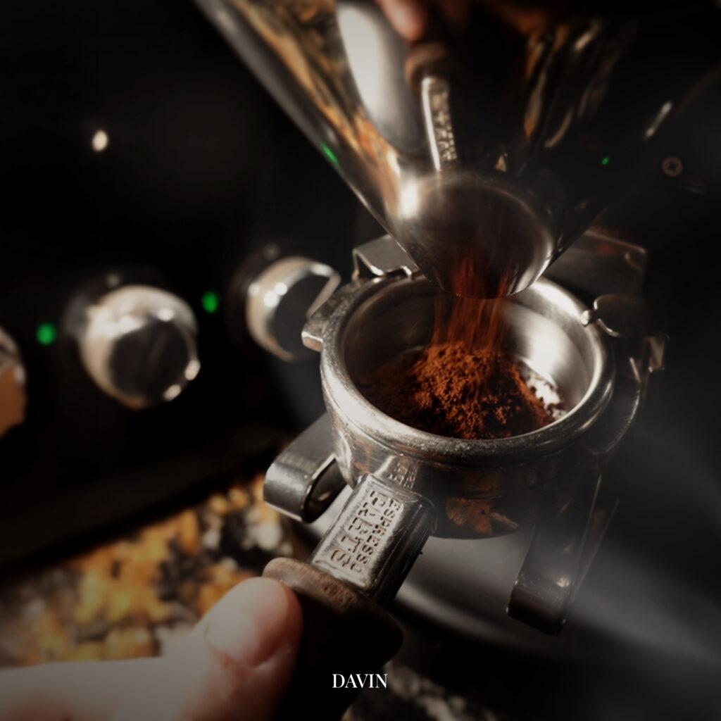 Freshly ground coffee being dosed into an espresso portafilter, highlighting the importance of grind size control in light roast coffee to achieve balanced extraction and clear aromatic expression