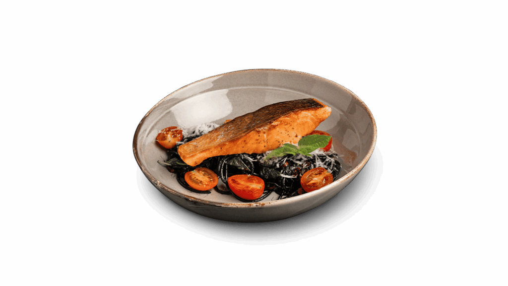 SALMON BLACK INK at DAVIN CAFE restaurant Bangkok featuring crispy skin grilled salmon on squid ink pasta with rich sauce, cherry tomatoes and herbs, a premium fusion seafood pasta in Bangkok restaurant scene for modern food lovers