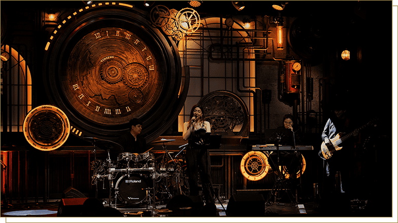 Live band performance at Vinsens bar showcasing a stunning mechanical clockwork stage design, perfect for night-out entertainment and cocktails.