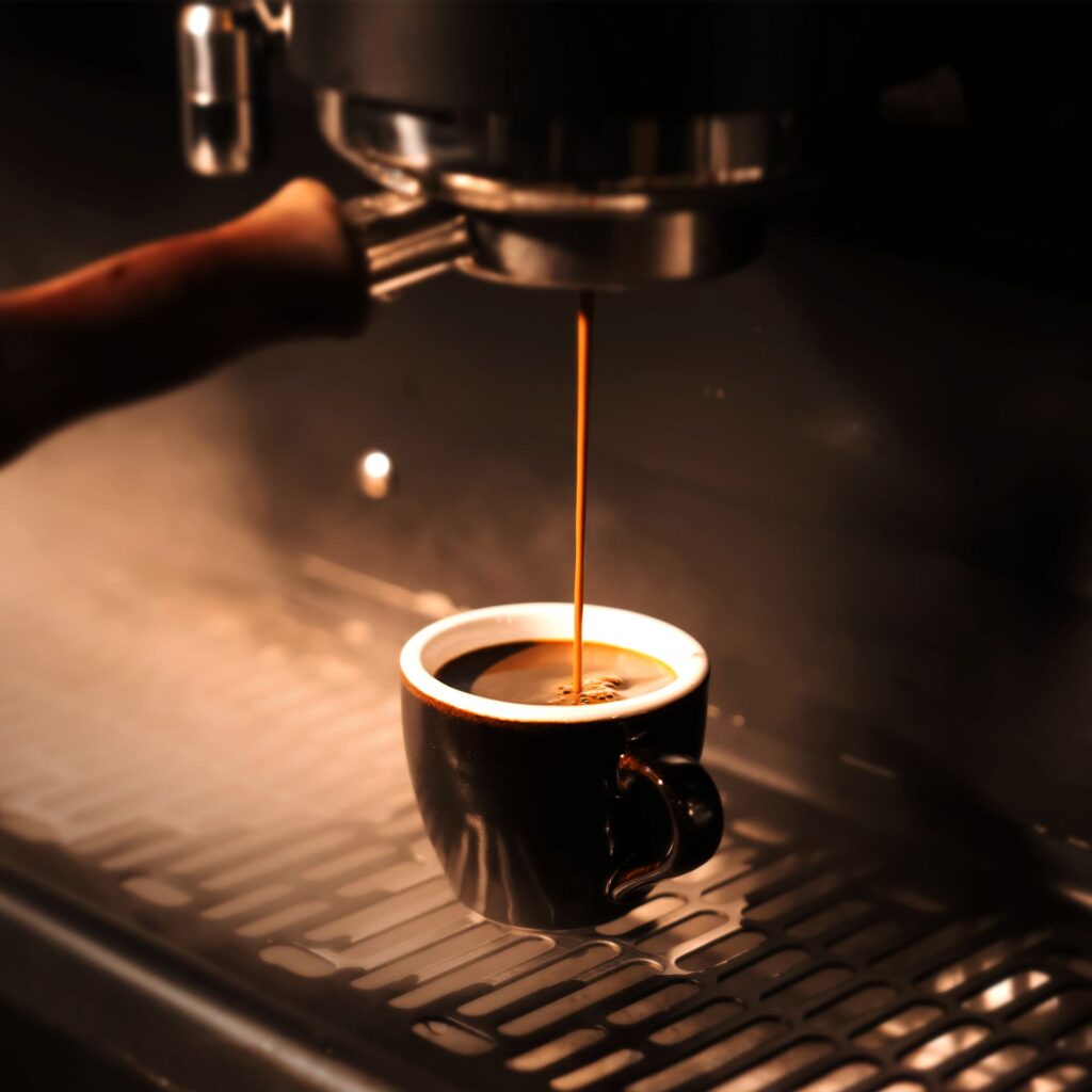 Authentic Espresso shot freshly extracted from a premium coffee machine at DAVIN CAFE Bangkok, a specialty coffee destination for true espresso lovers in Bangkok