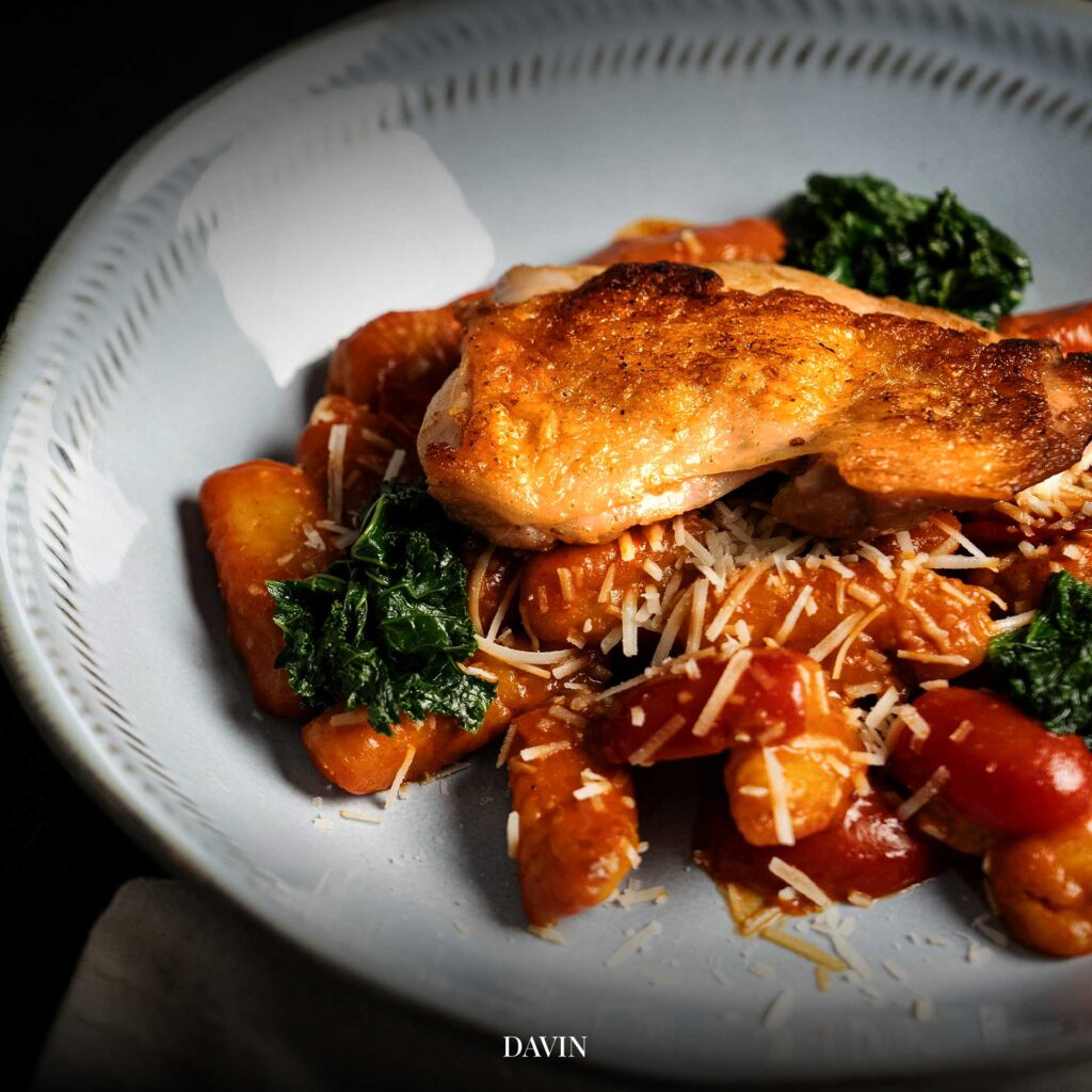 Creamy tomato gnocchi with crispy roasted chicken served at Davin Cafe Bangkok