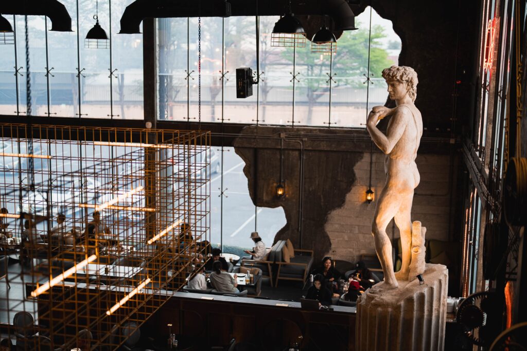 Luxury interior atmosphere inside DAVIN CAFE, a good atmosphere restaurant featuring high ceilings, elegant architectural design, cozy seating, and premium dining experiences in the city center