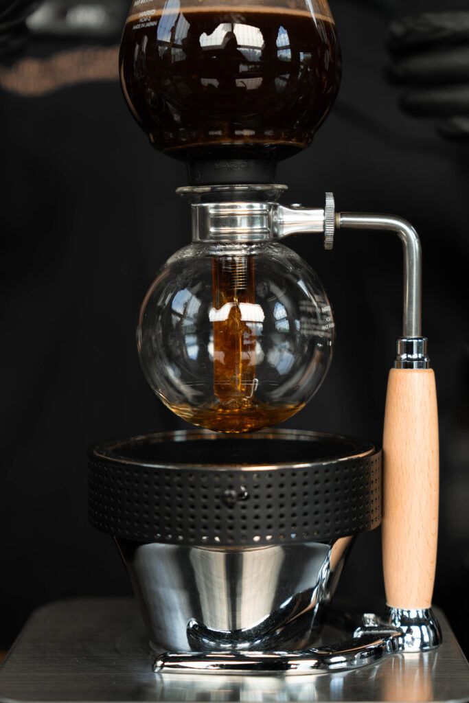 Siphon coffee brewing process at Davin Cafe specialty coffee bar in Bangkok, crafted with precision and detail