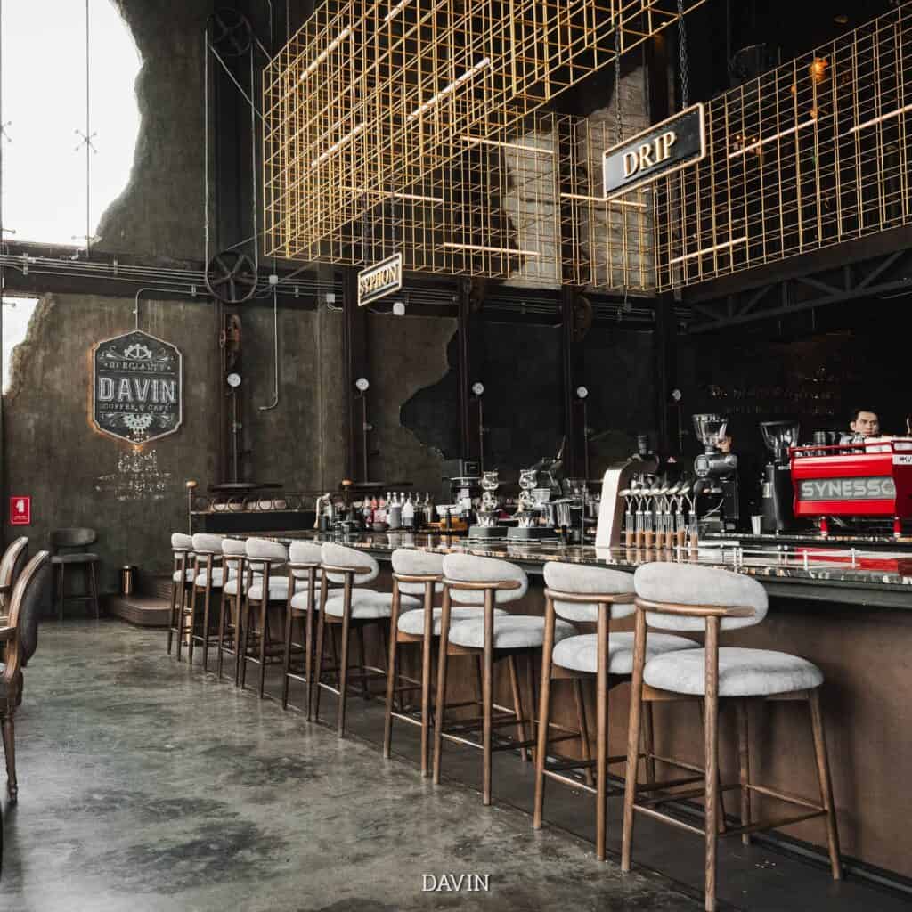 Specialty coffee bar at DAVIN CAFE, a Restaurant with Great Atmosphere Bangkok, featuring an industrial-inspired interior, high ceilings, premium coffee counter, and stylish seating for dining, coffee experiences, and social gatherings in Bangkok.