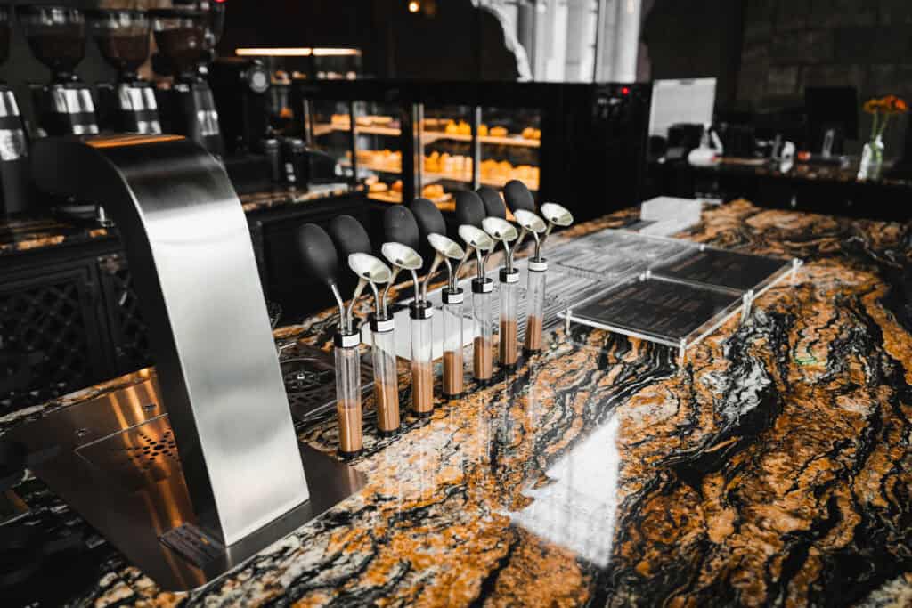 Specialty coffee bar counter at Davin Cafe in Ramintra, featuring brewing tools, aroma samples, and a marble-style countertop that highlights a refined breakfast cafe experience with quality coffee and a premium morning atmosphere.