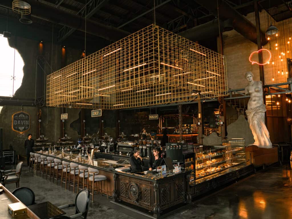 Spacious interior of DAVIN CAFE, a family restaurant in Ramintra with high ceilings, European-inspired design, and a large food and beverage counter