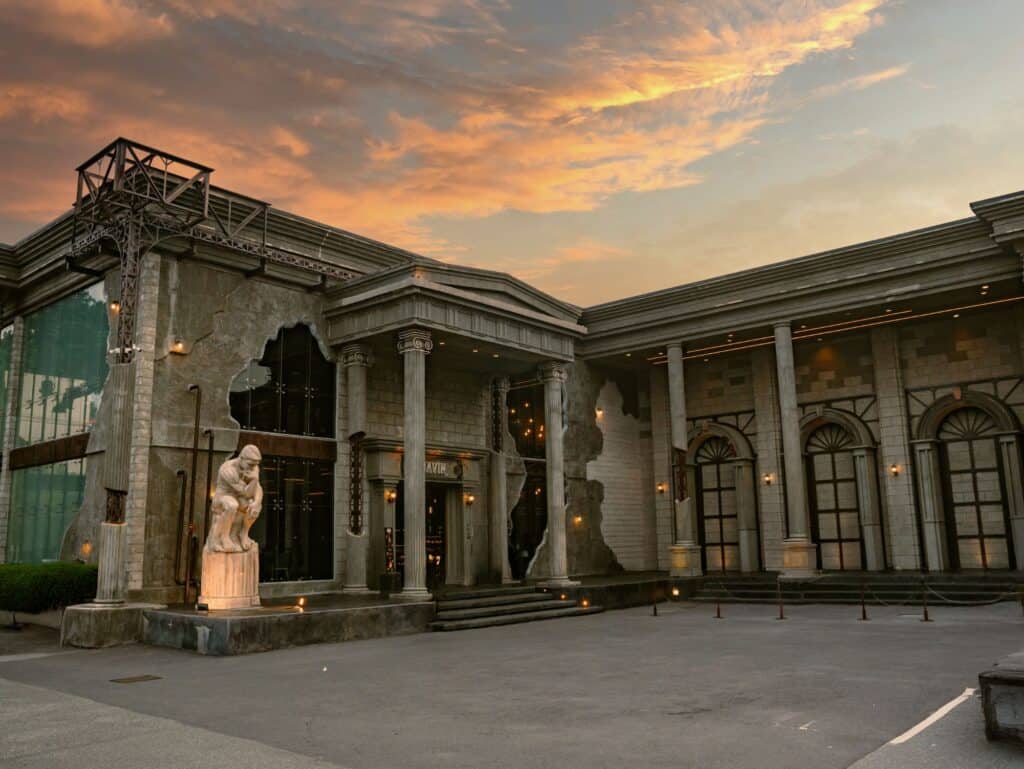 European-style exterior of DAVIN CAFE, a rainy day cafe in Ramintra, photographed in a warm evening atmosphere