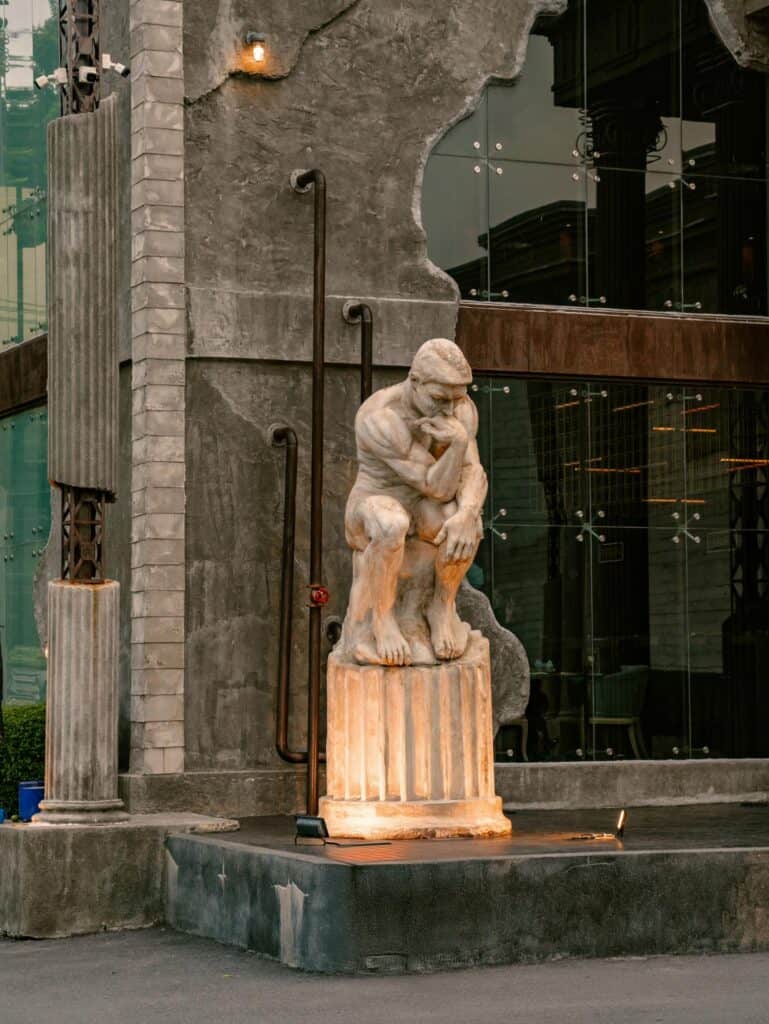 European-style cafe in Bangkok with a classical statue and distinctive architectural exterior at DAVIN CAFE