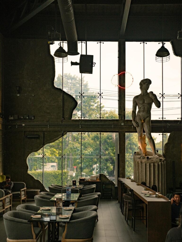 Photo cafe in Bangkok at DAVIN CAFE featuring a classic interior, natural light, and distinctive statue decor